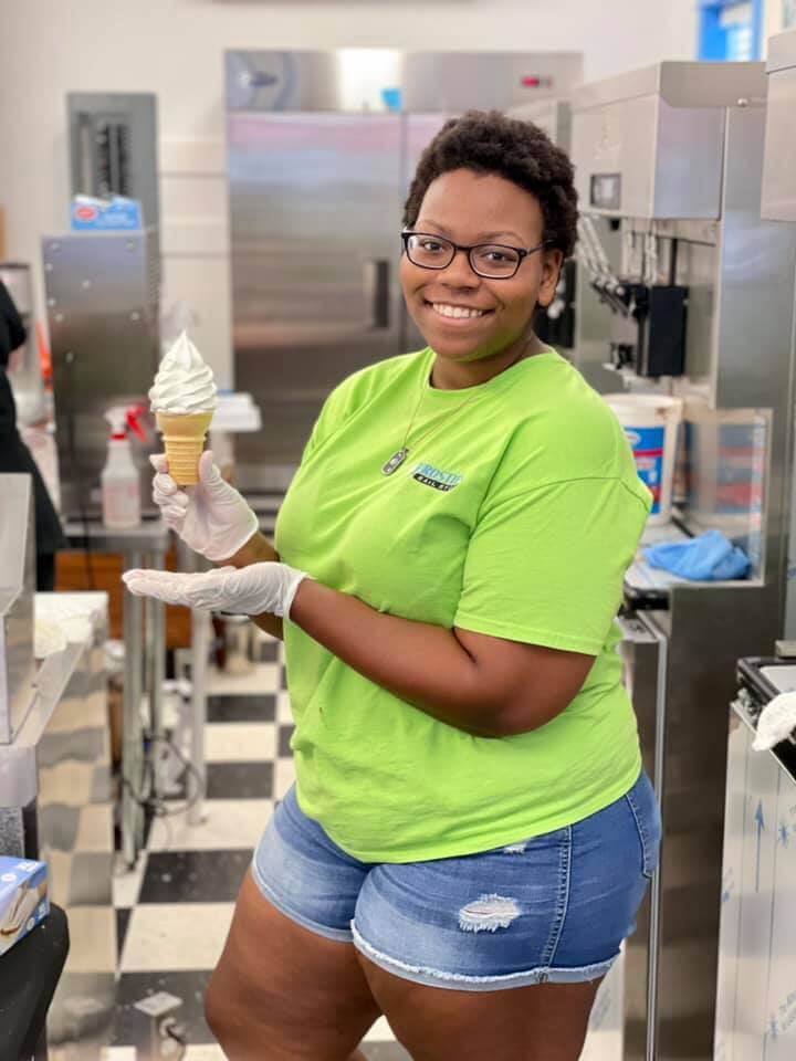 Ice cream employee showing off soft serve creation