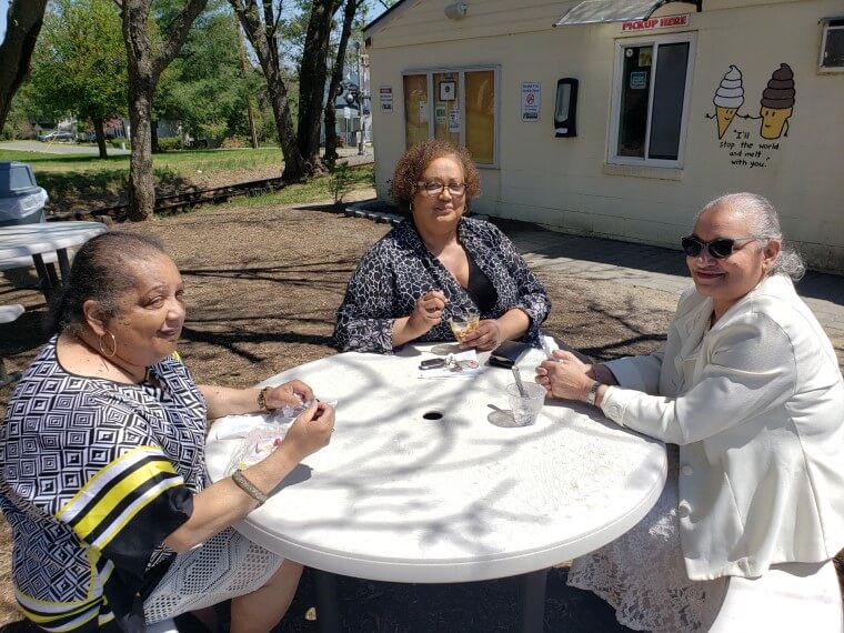 Group of nice ladies gathering for ice cream outdoors